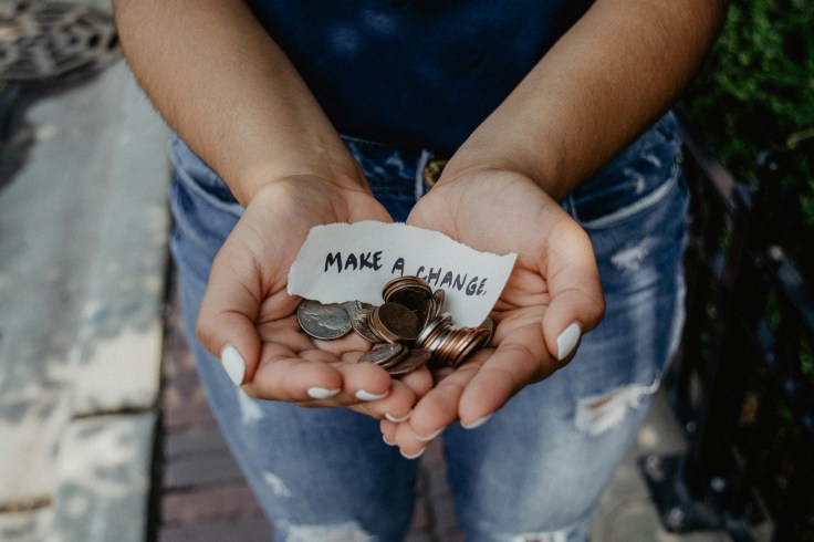 Hands holding coins and a note that reads "make change"